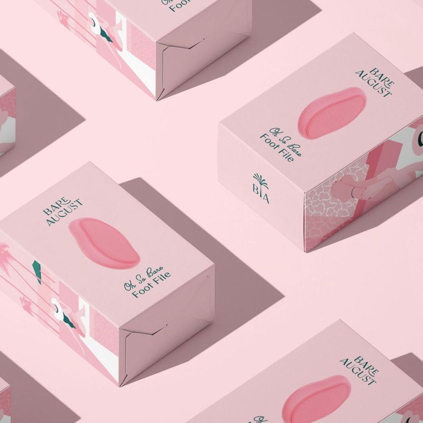 Tuck top crash lock box mockup featuring several pink packaging boxes with illustrated designs and product text on a pastel pink background.