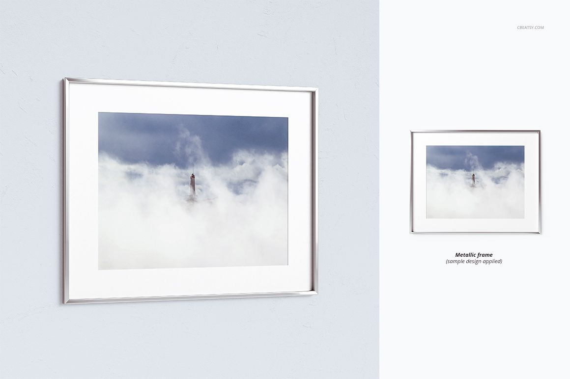 Thin metallic picture frame mockup with a landscape photo of a lighthouse in fog, shown on a light wall.