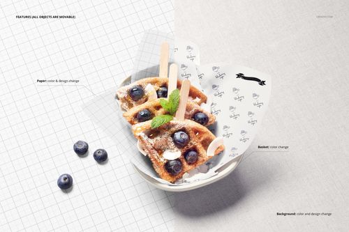 Top view of waffles with blueberries and mint served in a bowl lined with patterned food safe paper mockup.