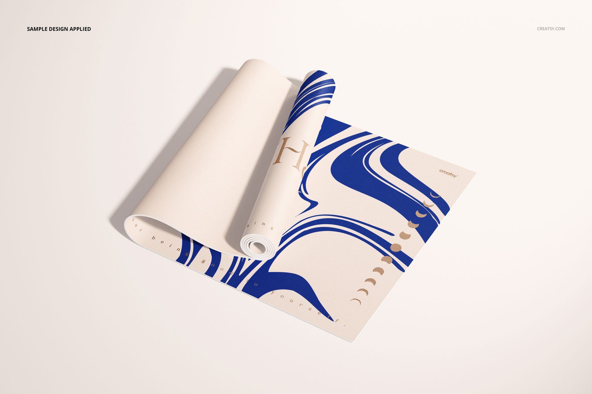 Yoga mat mockup displaying a rolled and open mat with blue swirls and gold geometric details on a white background.