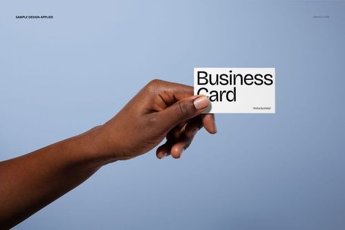 PSD mockup featuring a business card in a woman's hand, displayed with a minimalist blue background.
