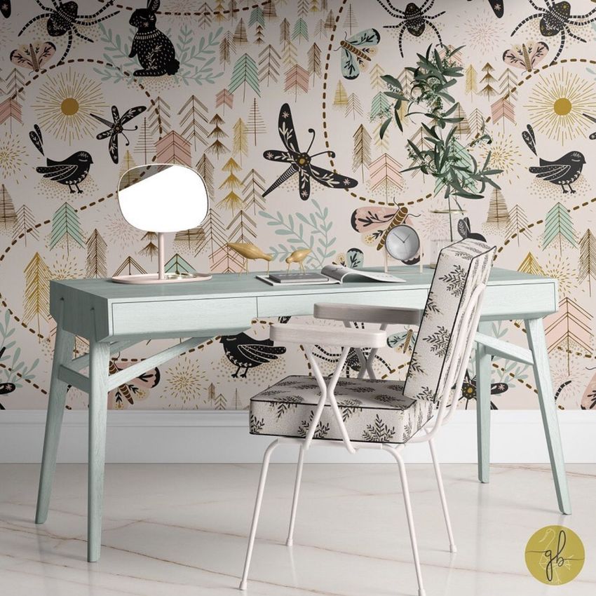 Modern workspace mockup showing a desk, chair, and playful wallpaper with birds, insects, and abstract foliage motifs.