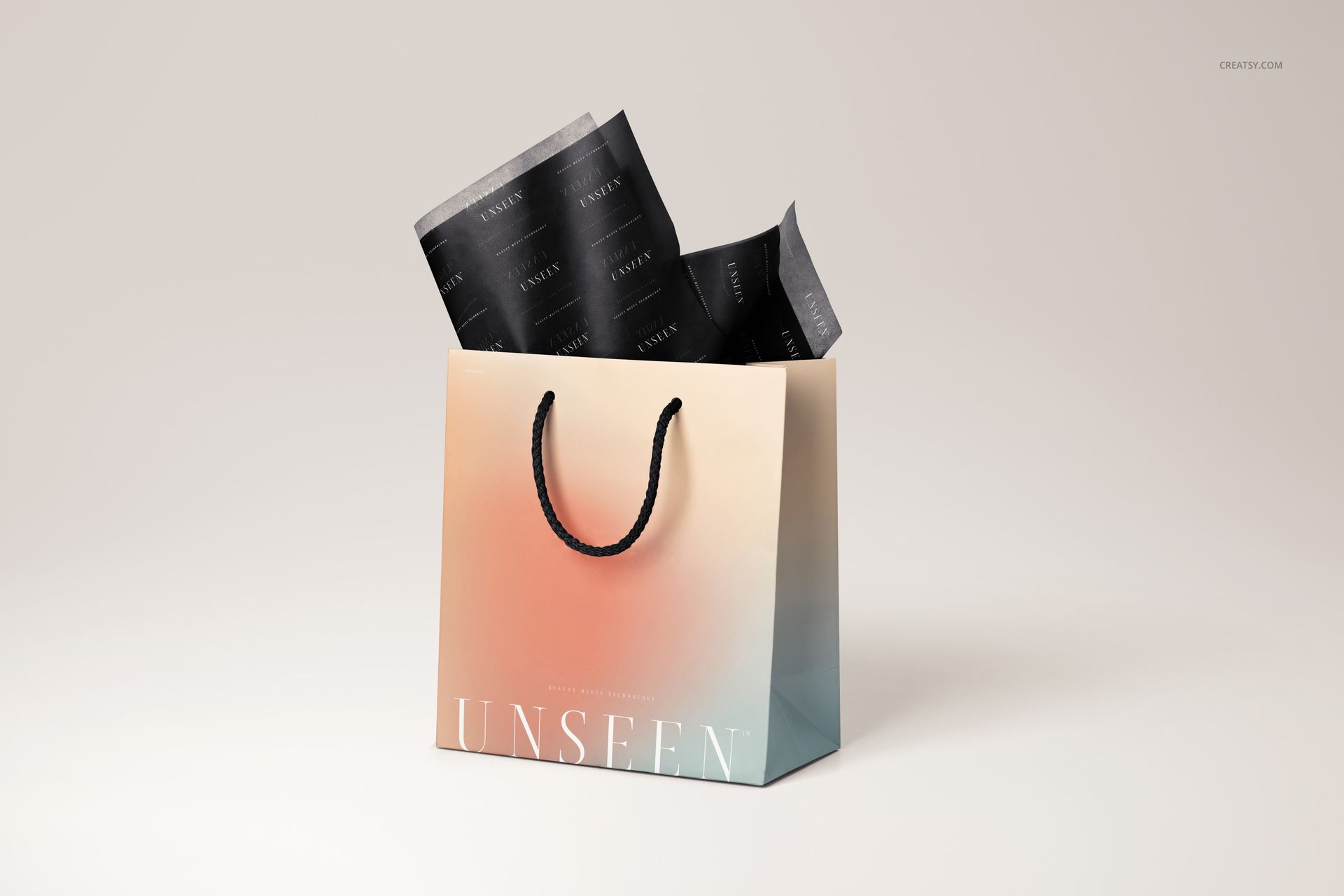 Mockup of a gift bag featuring a soft gradient, black rope handles, and black tissue paper with subtle text accents.