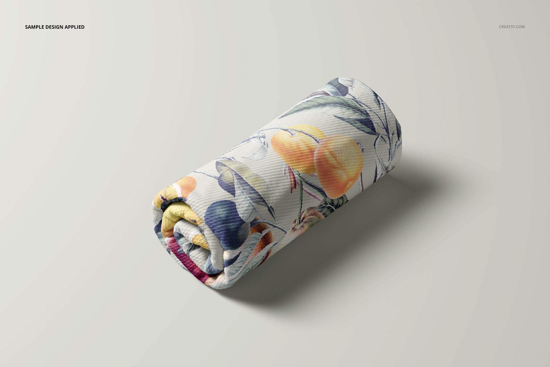 Rolled bullet fabric featuring a colorful fruit and leaf pattern, displayed on a light background in a PSD mockup.