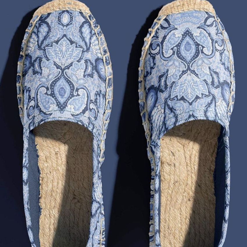 Canvas espadrilles mockup featuring a pair of shoes with intricate blue monochrome paisley patterns on a dark background.