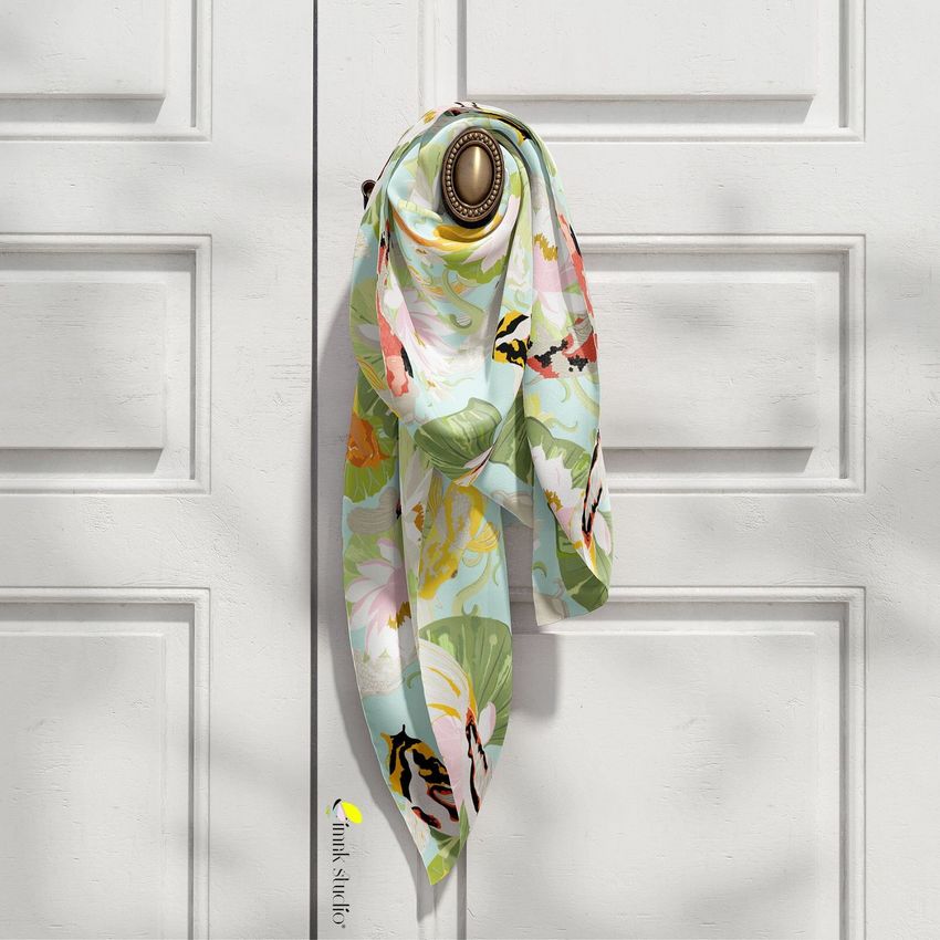 Silk scarf mockup featuring a pastel floral pattern, tied around a brass door handle on a white paneled door.
