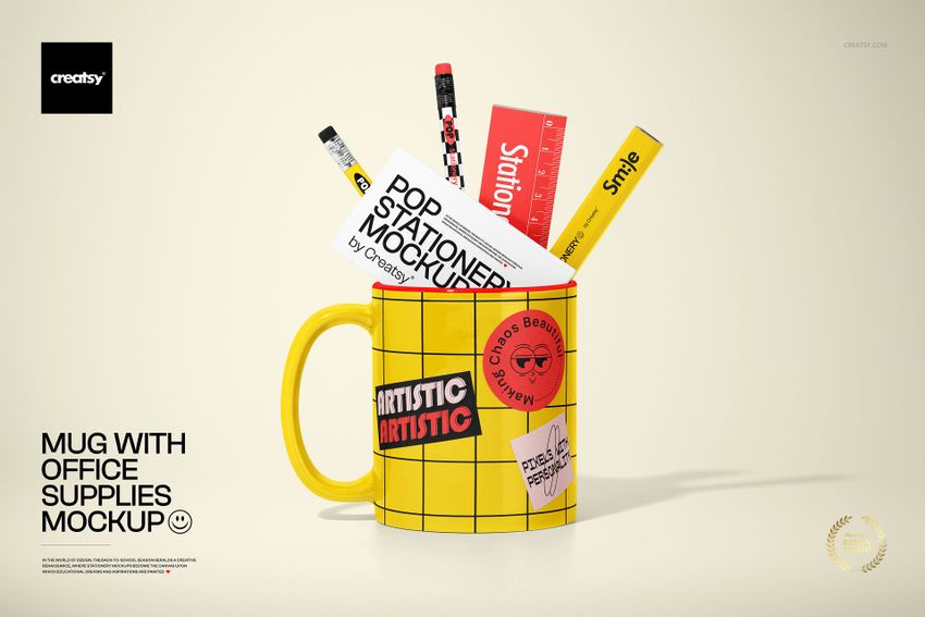 PSD mockup featuring a yellow mug with office supplies such as pens, ruler, and stationery cards, arranged on a light background.