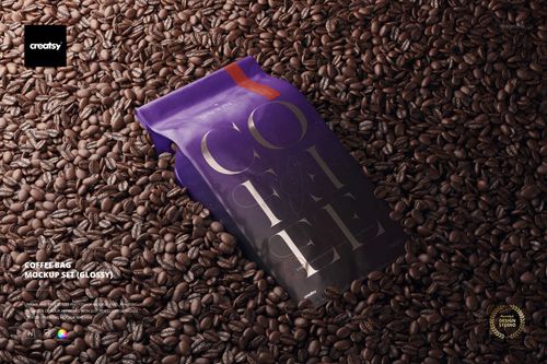 Glossy coffee bag mockup with purple and black design, placed on a surface covered with roasted coffee beans, top view.