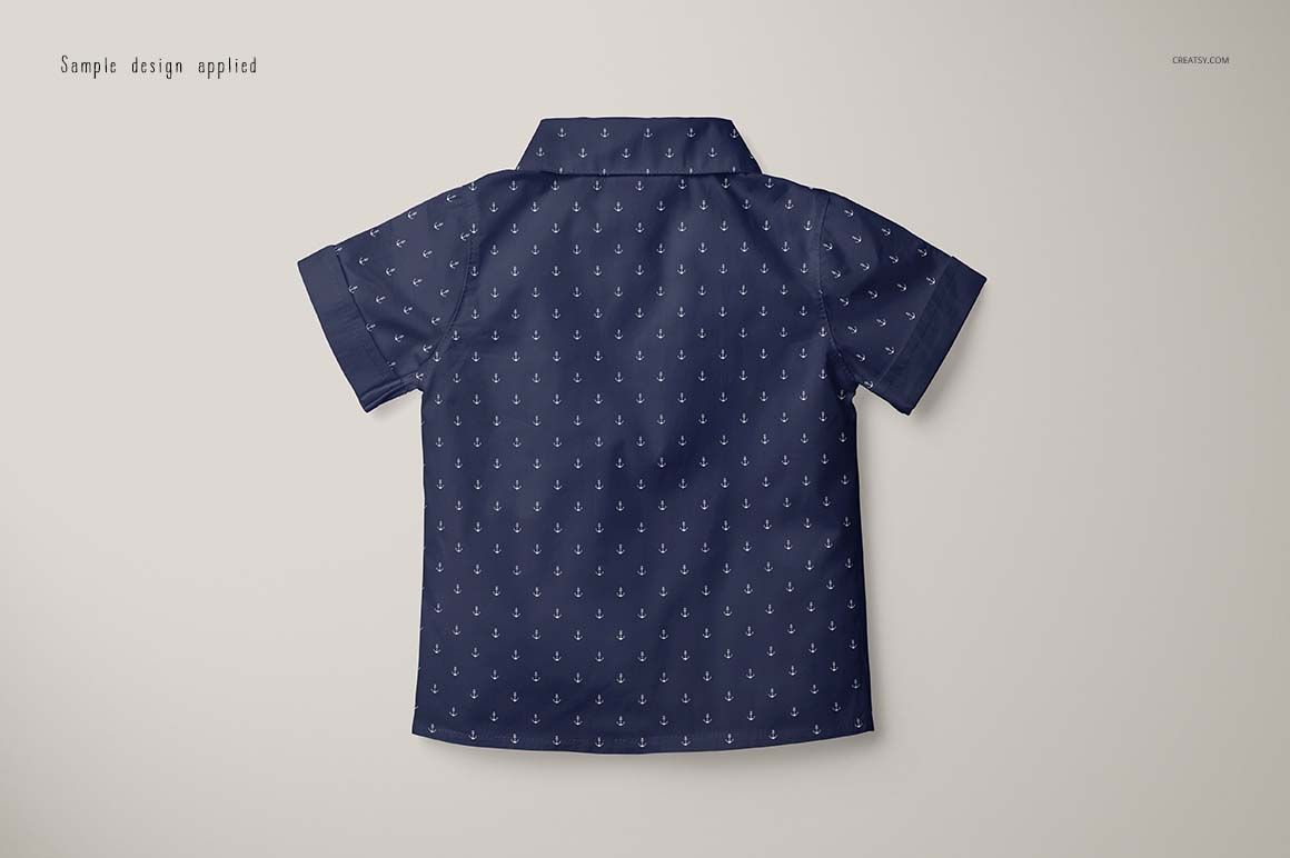 Boys formal shirt mockup in dark blue with small anchor motifs, displayed from the rear on a neutral surface.