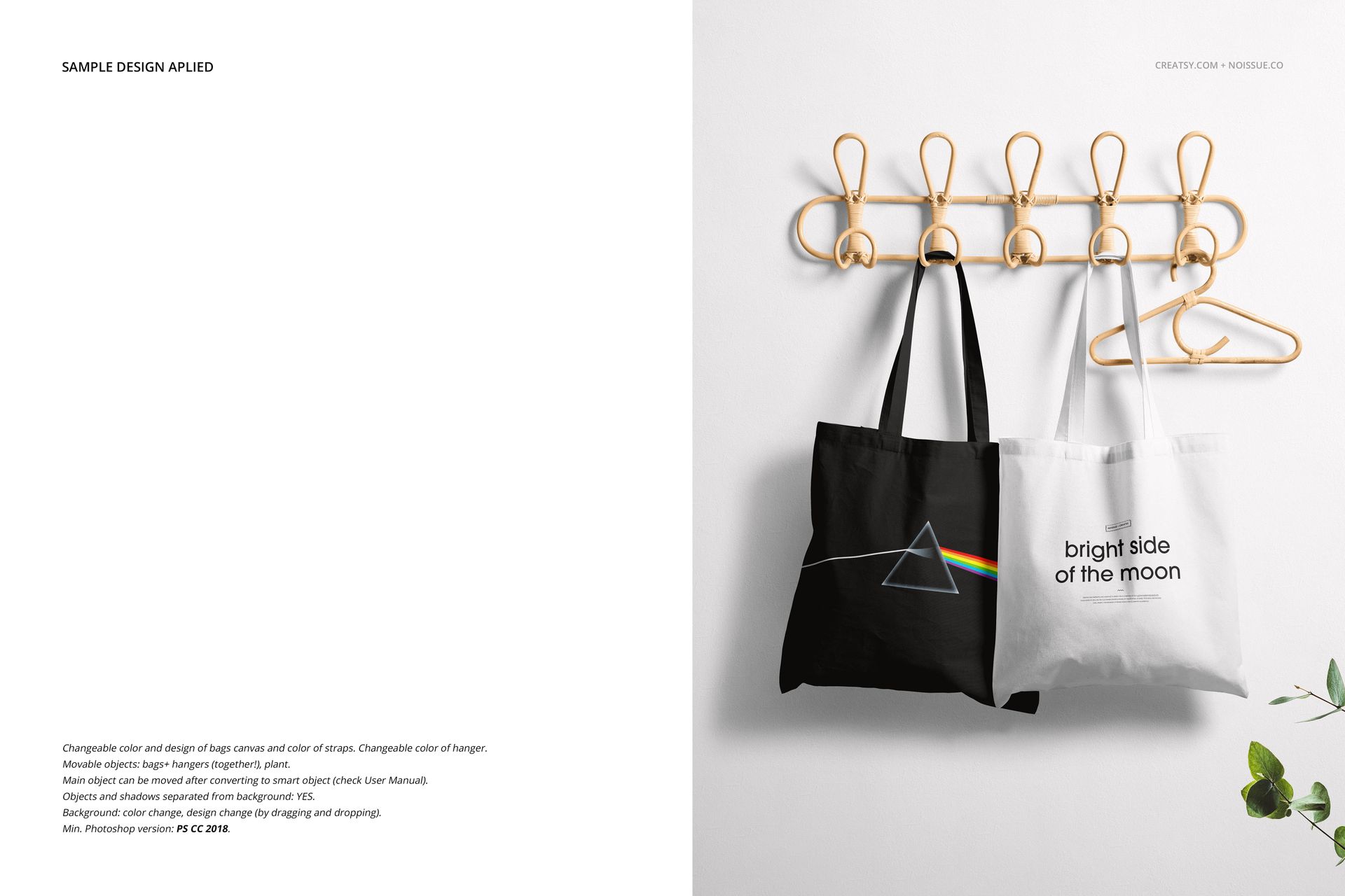 Two tote bags, one black and one white, hanging on a light wooden wall rack with gold hooks against a white background.