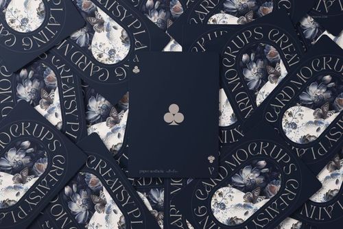 Playing cards mockup featuring a dark blue deck with floral patterns and club suit symbols, viewed from above.