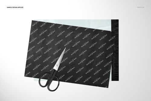 Black mailer bag and translucent tissue paper mockup shown from a top view with scissors placed on top.