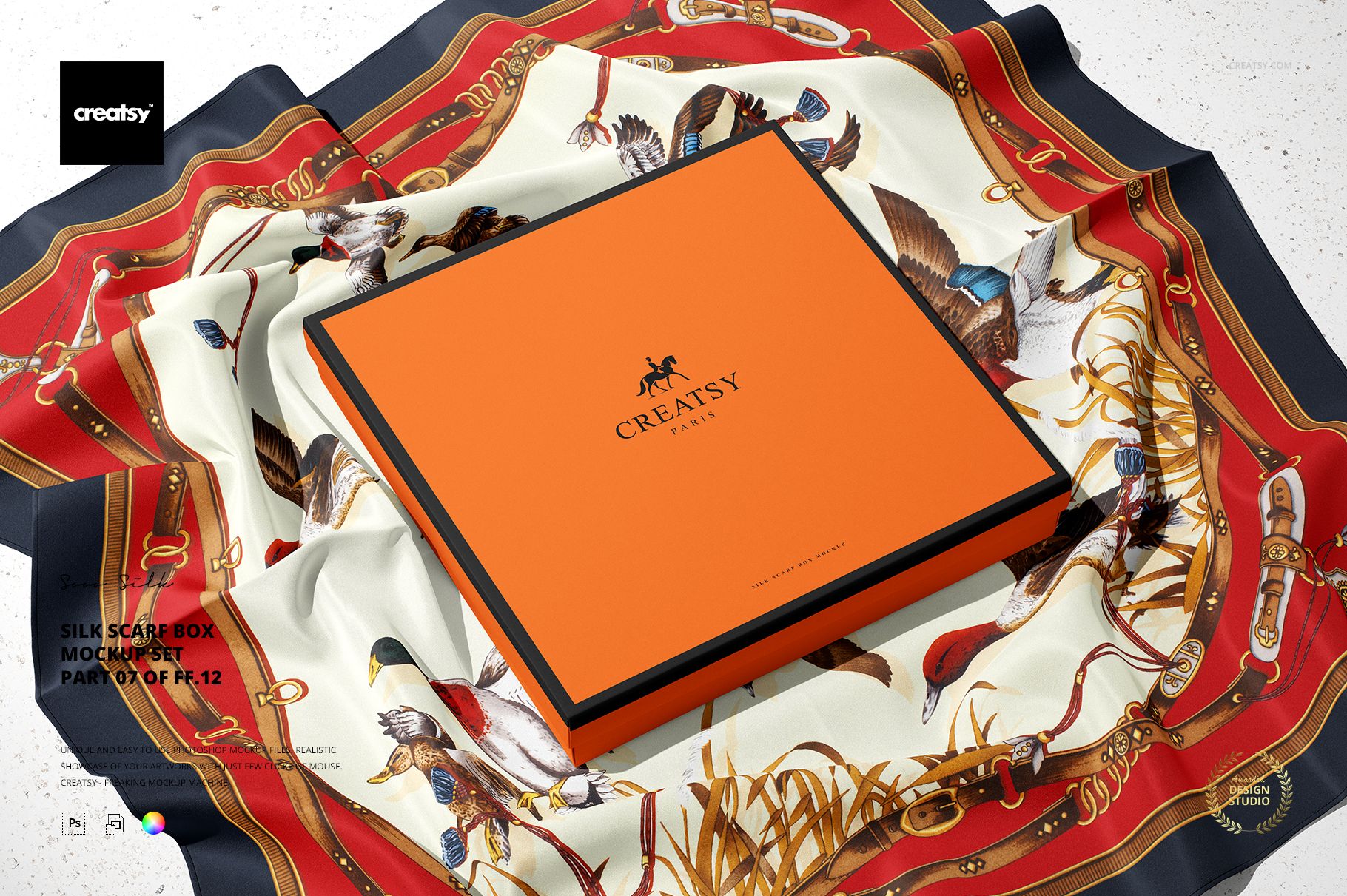 PSD mockup showing a flat square box on a decorative silk scarf with detailed patterns, photographed from a top perspective.