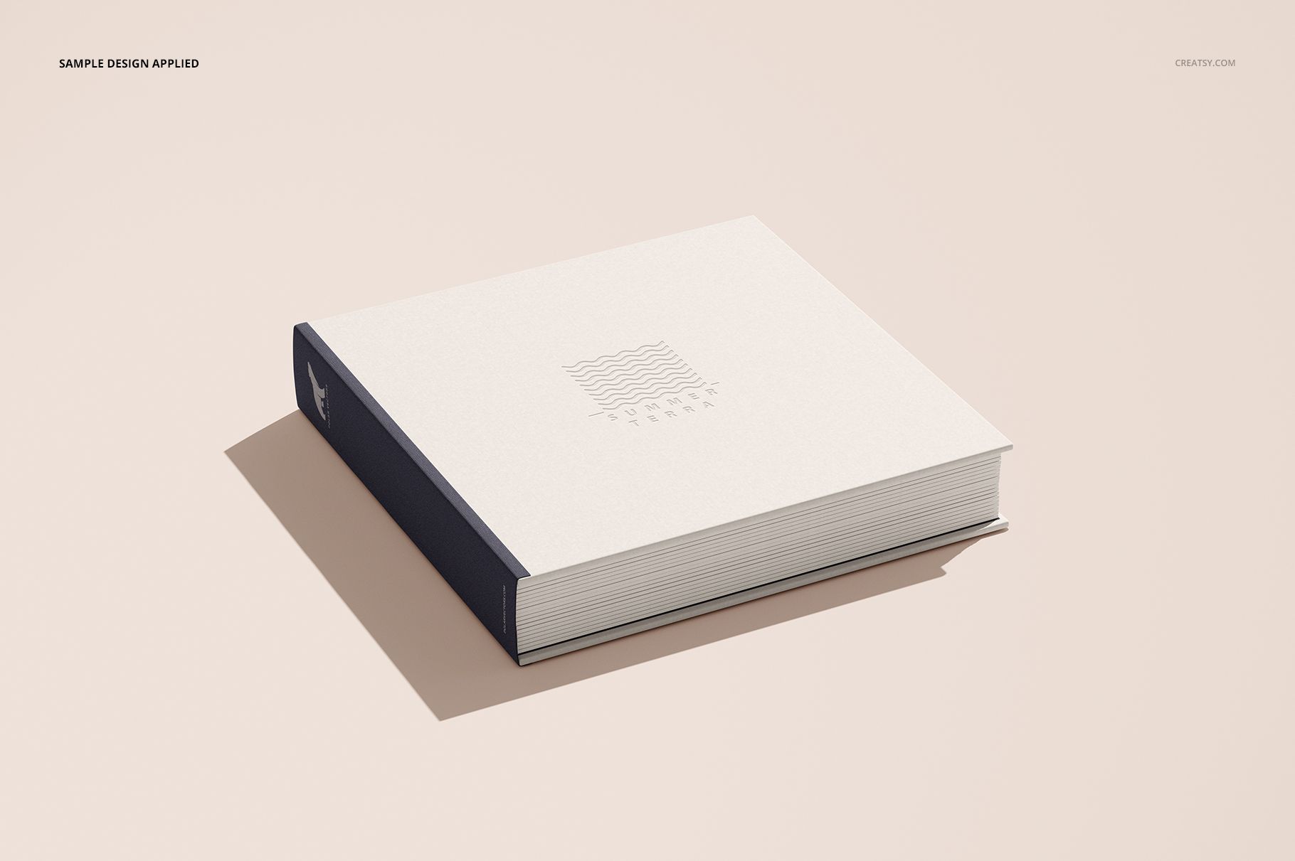Closed artbook mockup featuring a minimalist white cover and navy spine, shown from a slightly elevated perspective.
