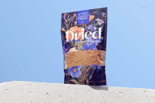 Front view of a paper pouch mockup for golden flax seeds, featuring floral patterns and clear product window.
