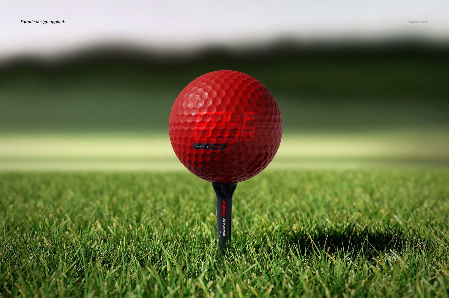 Golf ball mockup featuring a bright red ball on a tee, close-up view with grassy field and soft focus backdrop.
