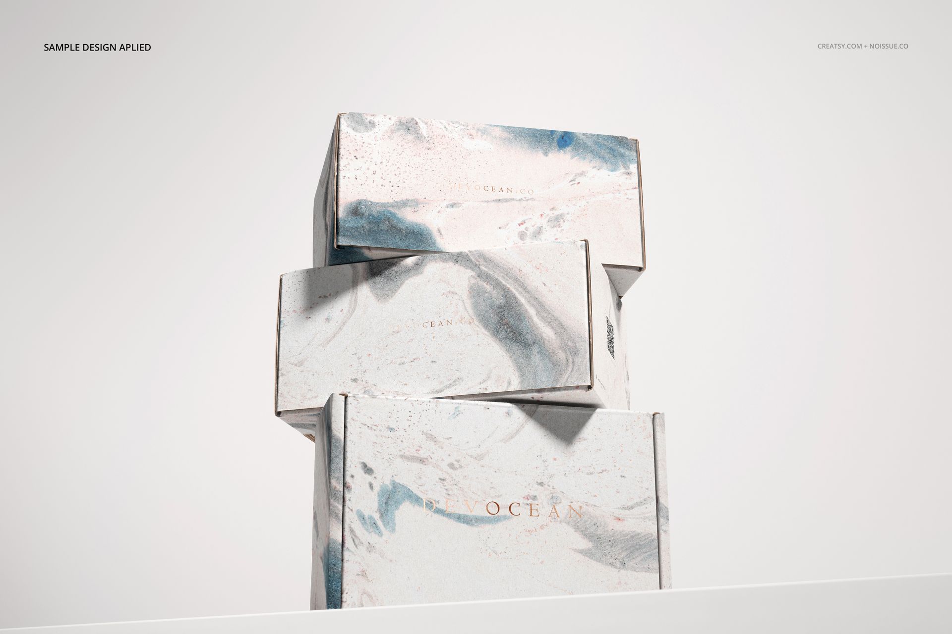 Three packaging boxes featuring a blue and beige marbled pattern, arranged in a vertical stack, PSD mockup style.