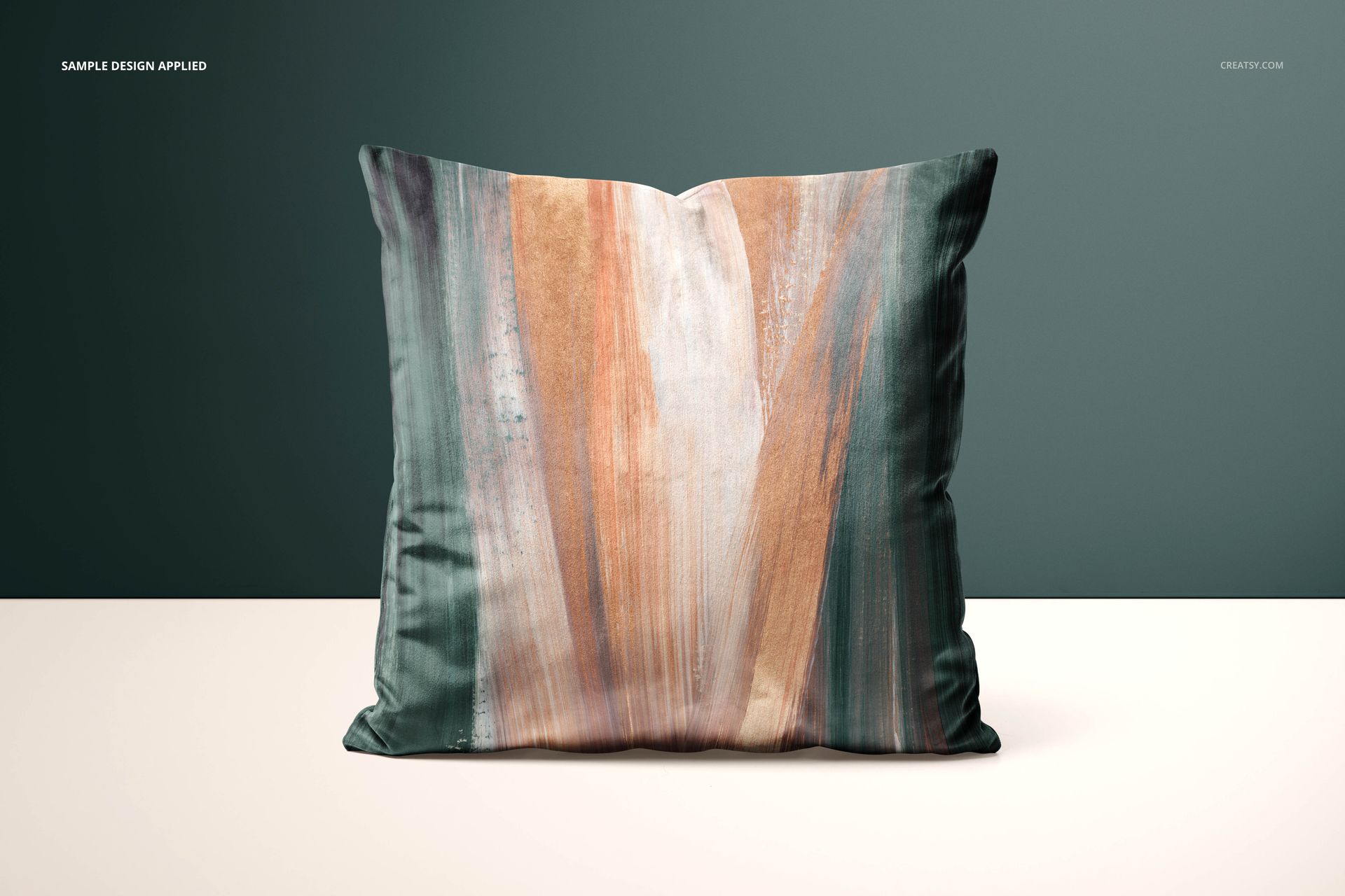 Velvet cushion PSD mockup showing a square pillow with artistic vertical stripes in muted colors, against a dark green backdrop.