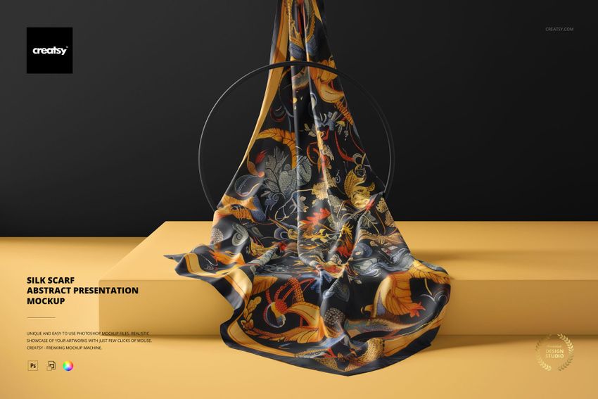 Silk scarf with abstract floral and bird pattern displayed draped over a yellow platform, front view, mockup scene.