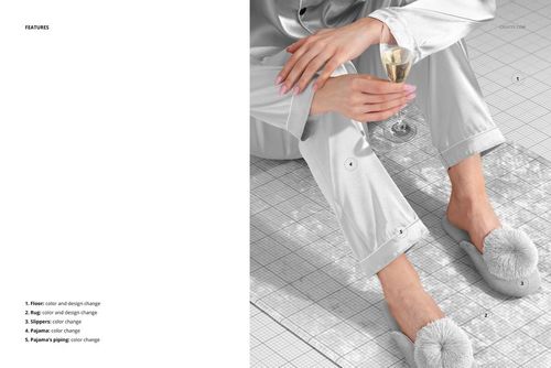 Top view of a marbled velvet rug mockup on a grid background, with a person in silver pajamas holding a glass.