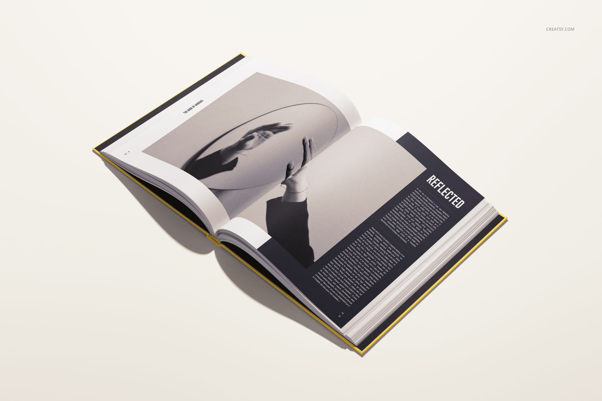 Open hardcover book mockup displayed at an angle, featuring a modern design with image and article on the pages.