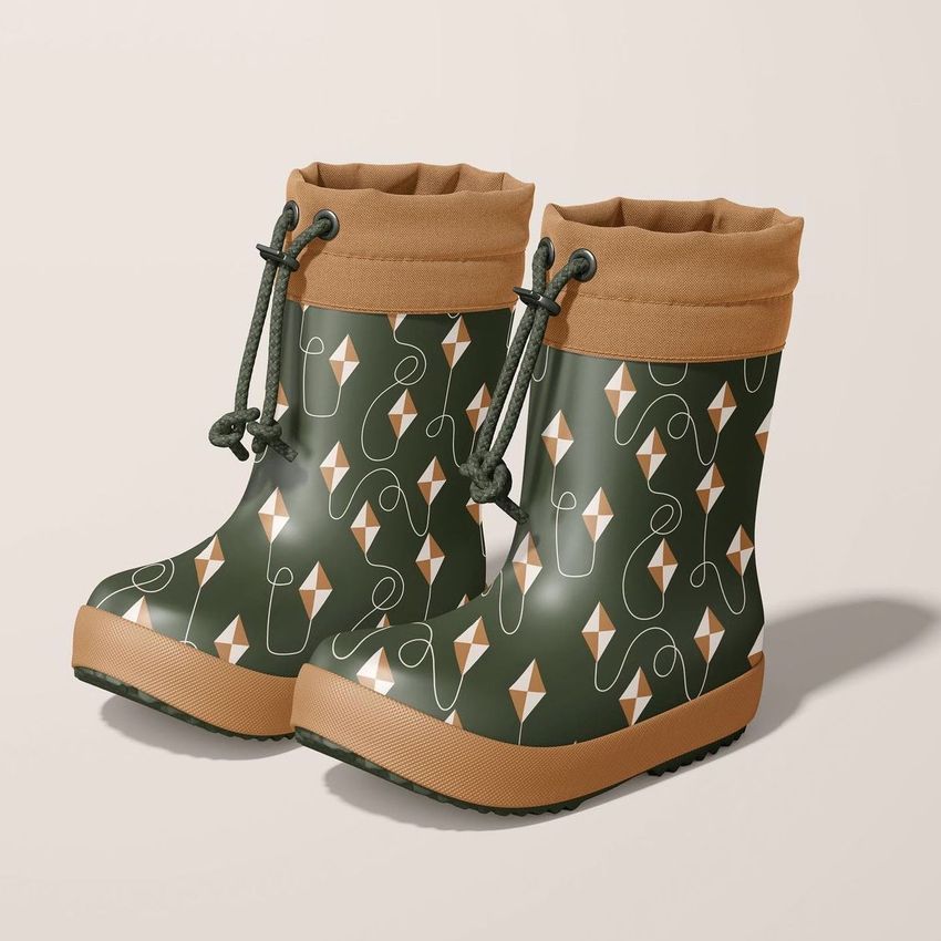 Rain boots mockup featuring a pair of green boots with tan cuffs and a geometric kite pattern, shown on a light background.