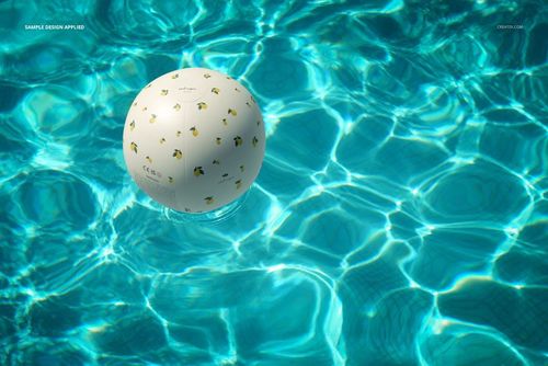 PSD mockup of a patterned beach ball on shimmering turquoise water, showing ripples and reflections, overhead perspective.