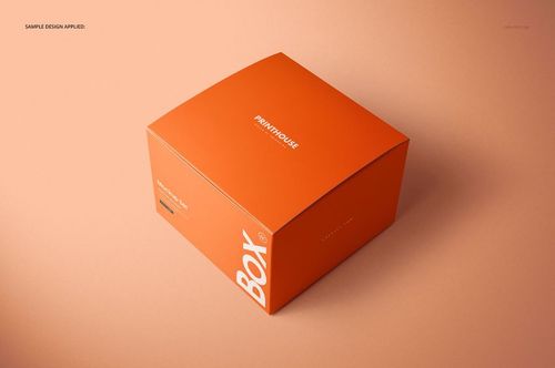 Orange chipboard gift box mockup with gloss finish, featuring white lettering, displayed in a studio setting.