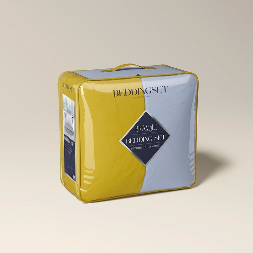 Transparent bag bedding packaging mockup featuring a square clear plastic bag with yellow trim and handle, set against a beige background.