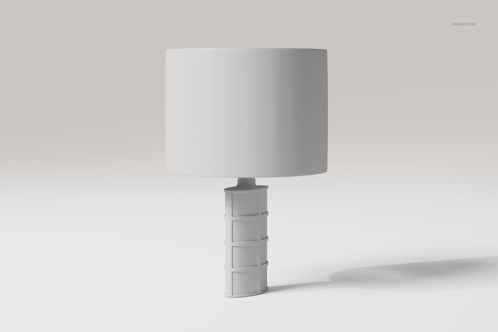 Front view of a decorative table lamp with a cylindrical white shade and a geometric textured base on a plain background.