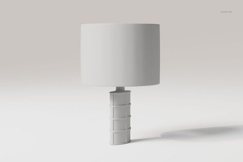 Front view of a decorative table lamp with a cylindrical white shade and a geometric textured base on a plain background.