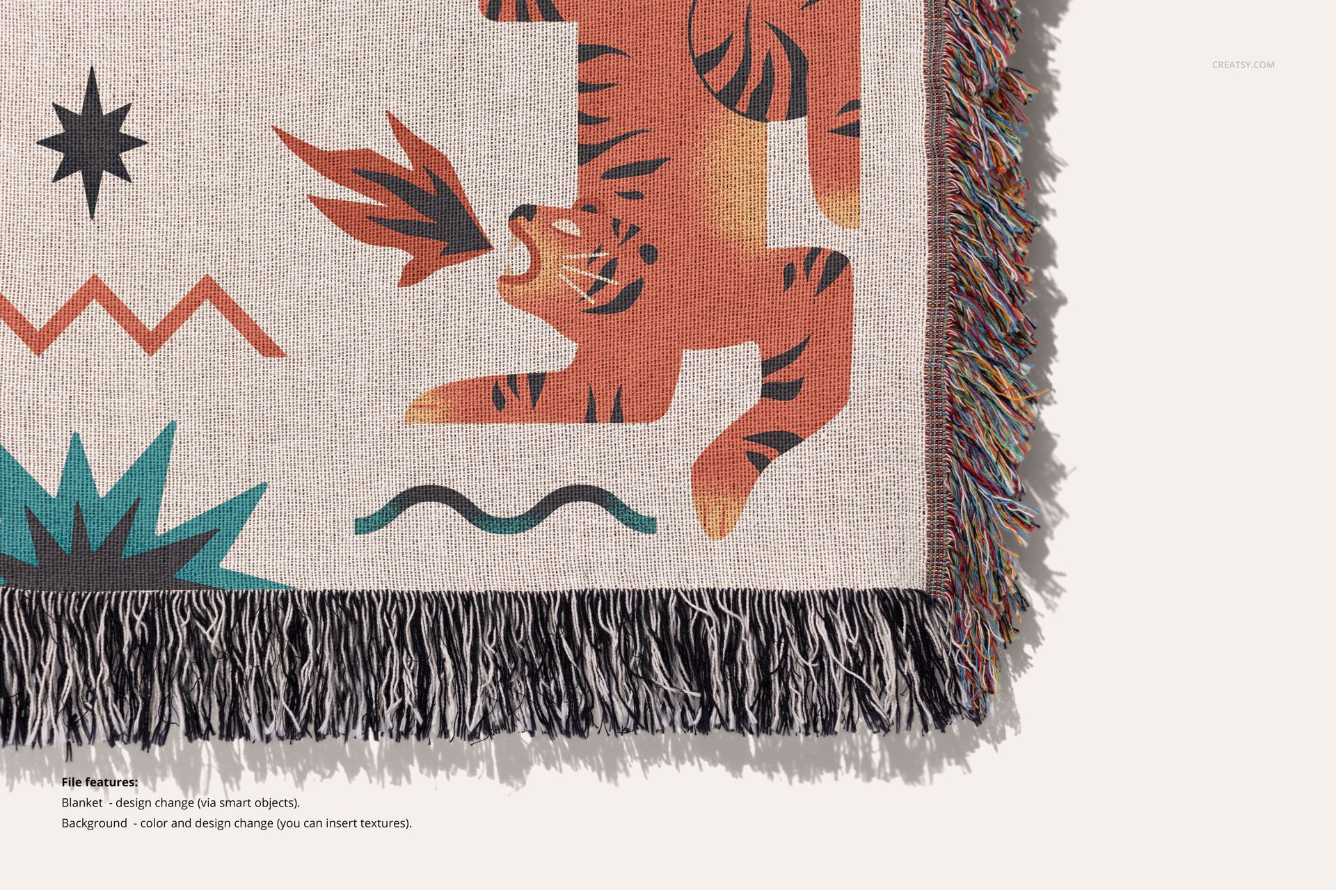 Jacquard fringed blanket mockup showing colorful animal pattern and textured border on a light background, top angle.