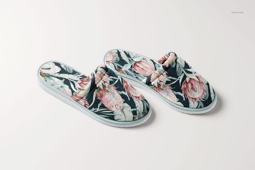 PSD mockup of two home slippers with botanical design, arranged on a clean white surface, semi-top perspective.