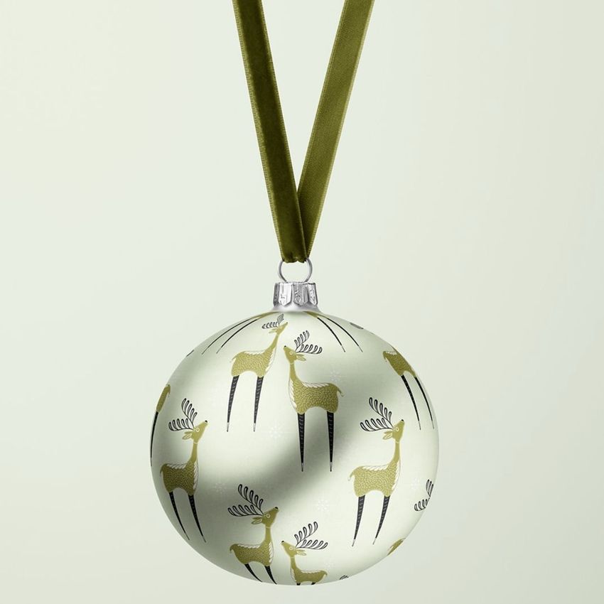 Satin Christmas ball mockup featuring a repeating reindeer pattern in green and black, hanging from a velvet ribbon.