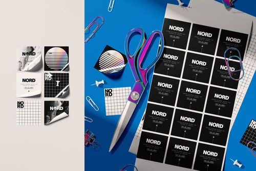 PSD mockup of square stationery stickers in various geometric and text designs, arranged with office supplies in view.