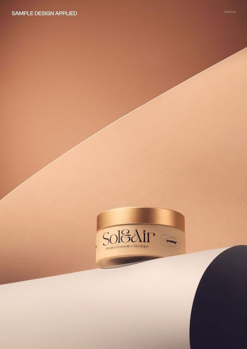 Cream glass jar with metallic cap displayed on a rolled paper backdrop, shown from a front angle in a cosmetics mockup.