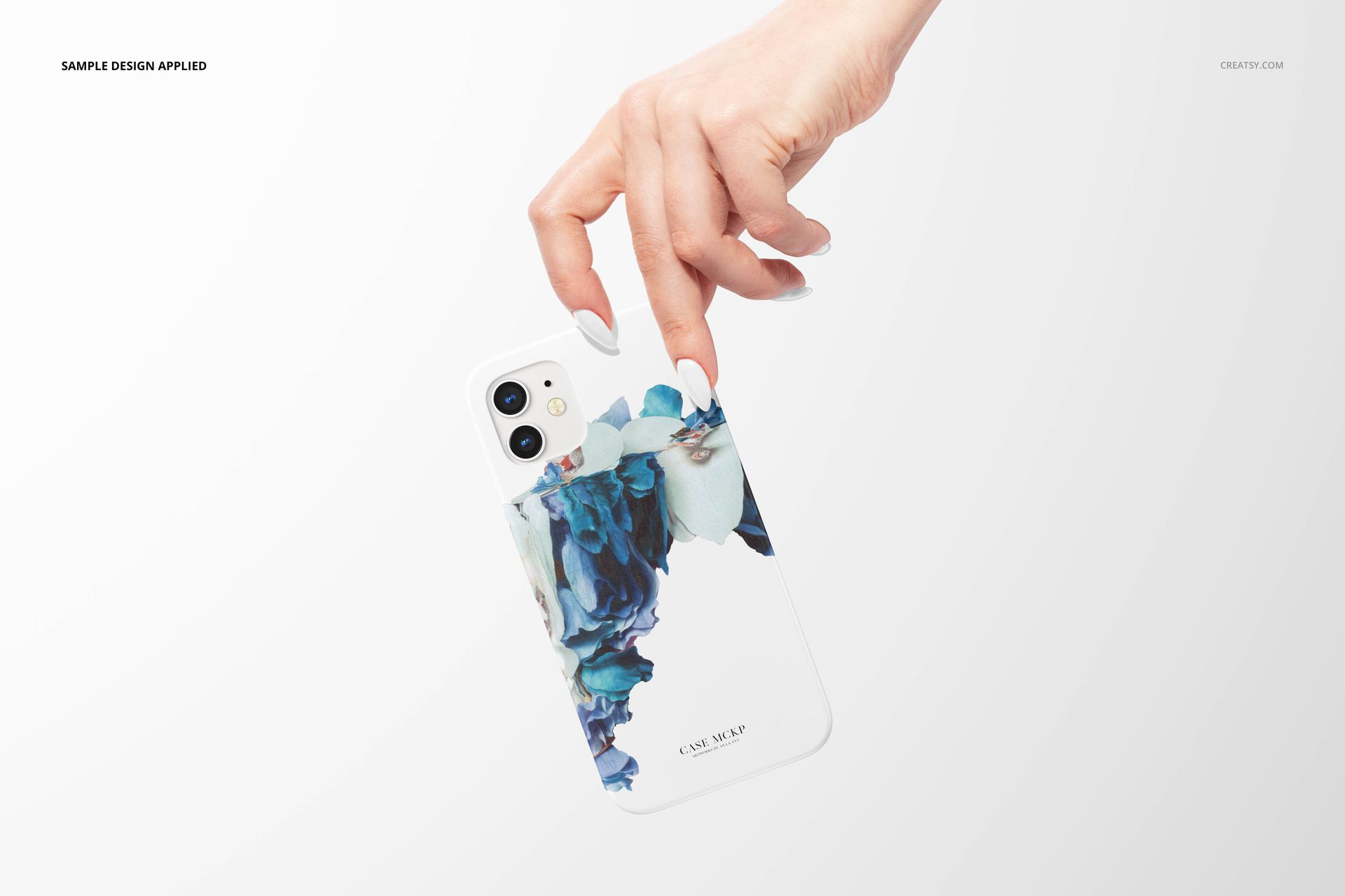 iPhone 12 matte snap case mockup shown from the back, decorated with blue and white artistic floral accents.