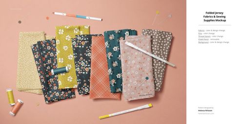 PSD mockup of patterned jersey textiles in assorted colors, surrounded by sewing accessories on a light peach background.