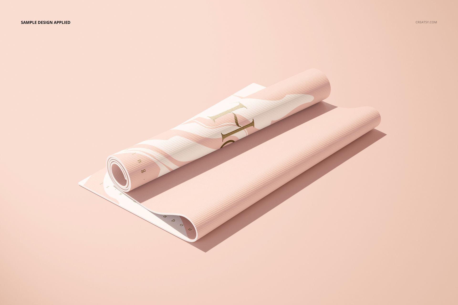 Yoga mat mockup featuring a rolled and flat section, light pink tones, and minimal gold design, viewed from above.