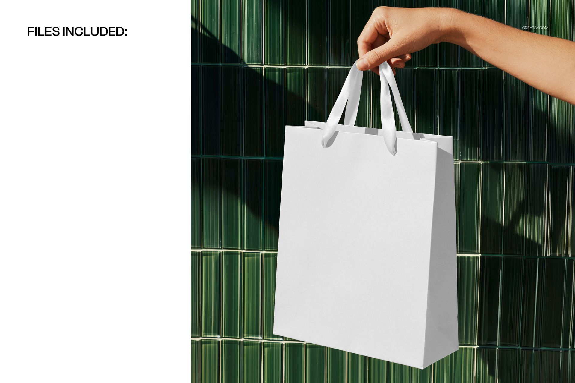 White gift bag mockup held by a hand, shown from the front with a green vertical panel background.