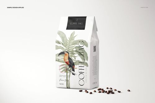 Paper coffee bag mockup featuring a tropical plant and bird illustration, shown with coffee beans on a clean background.