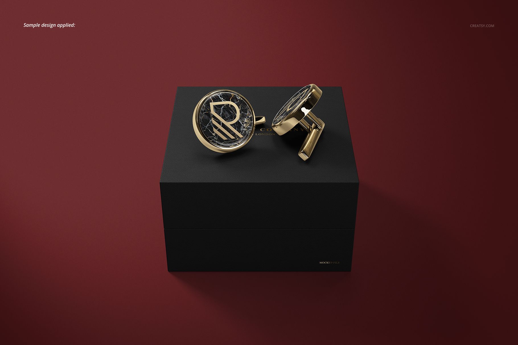 Elegant cufflinks mockup set with metallic accents and circular detailing, presented on a black box against a red surface.