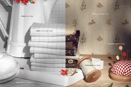 PSD mockup showing folded jersey fabrics in different colors and designs, pitcher, flowers, and sewing props on a wooden surface.