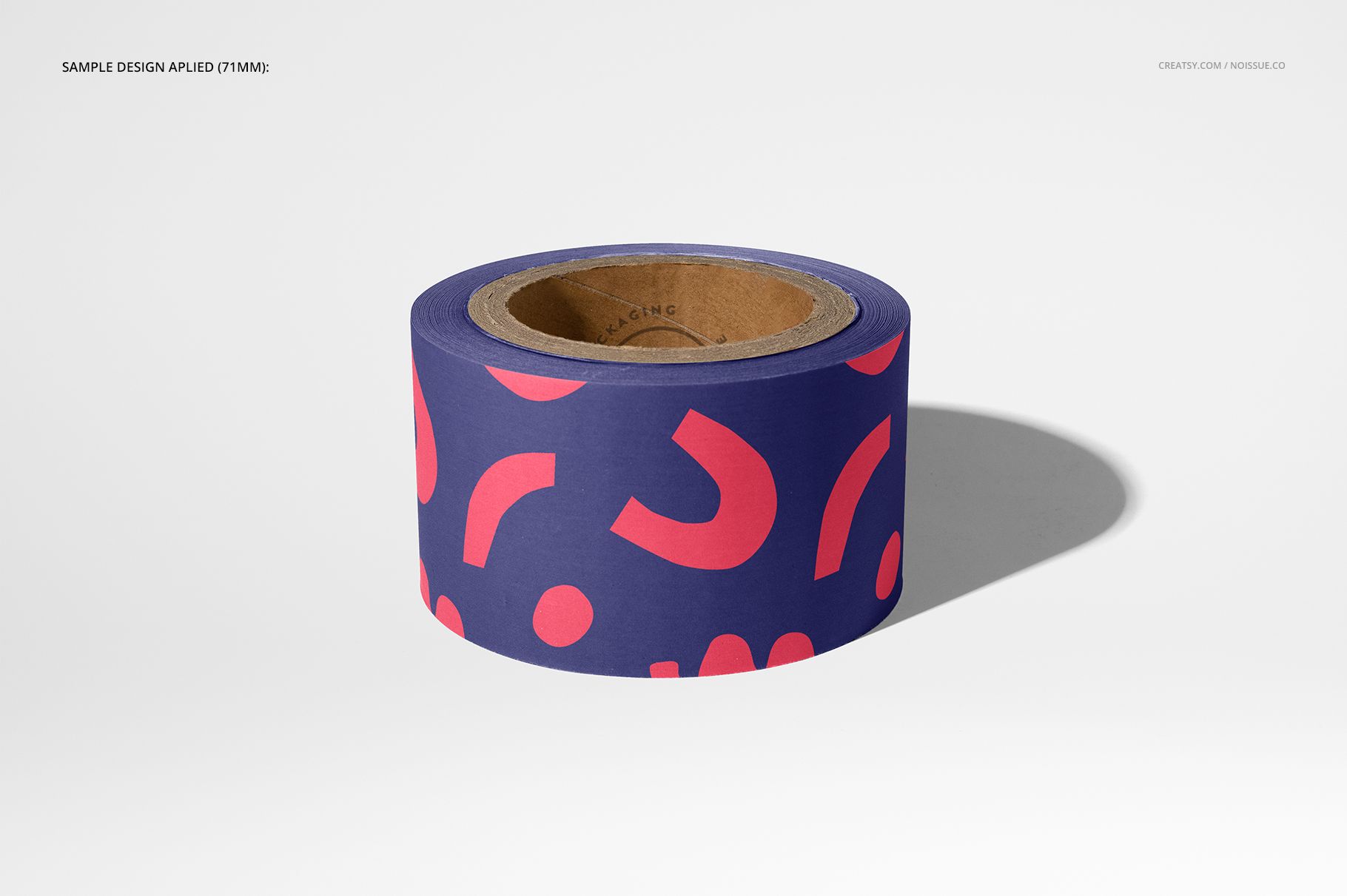 Packing tape mockup featuring a roll with pink geometric pattern on navy, shown from the front with shadow.