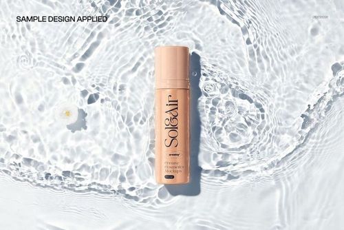 Beige cosmetics packaging mockup displayed on clear water surface with gentle ripples and flower accent.