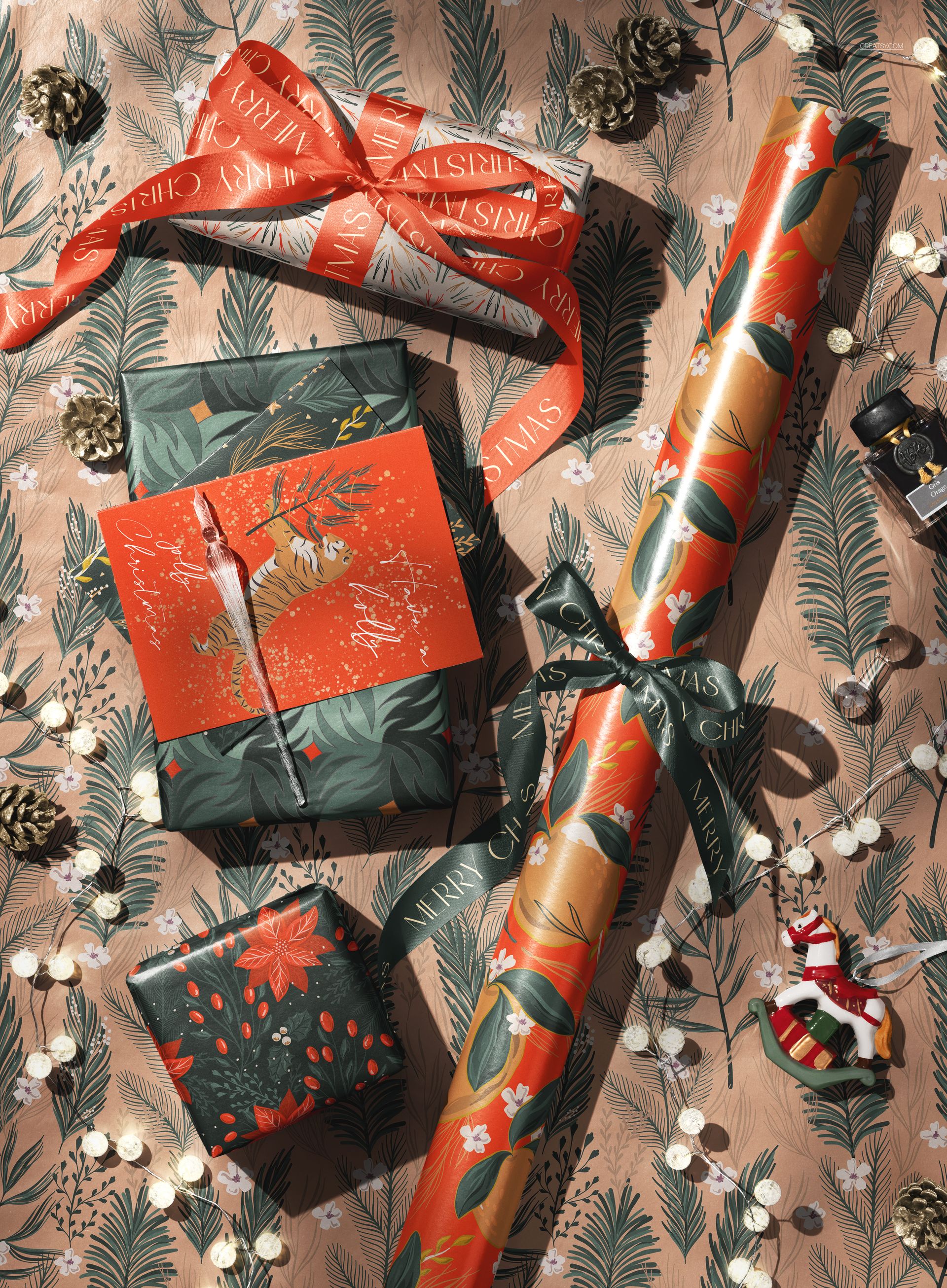 Christmas wrapped gift boxes with festive ribbons and patterned wrapping paper, viewed from above on a decorated surface.