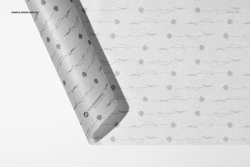 Rolled tissue paper mockup with subtle gray floral pattern, viewed from above on a white background.