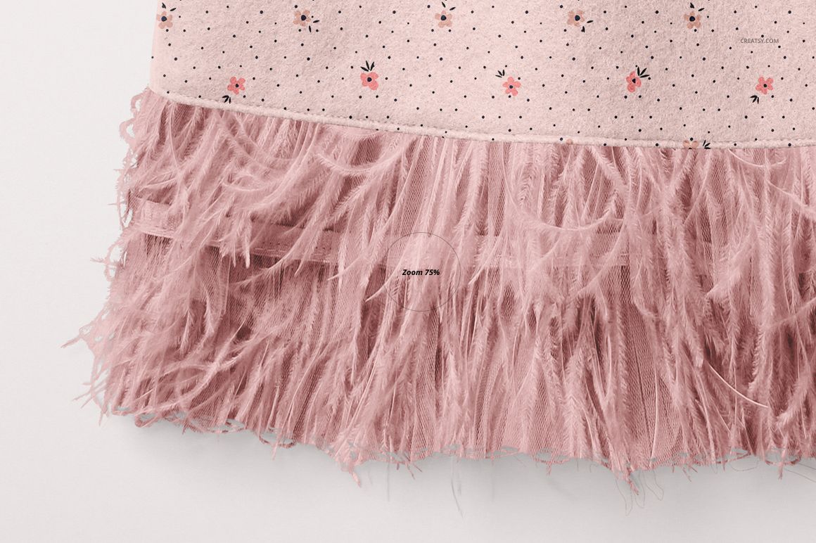 Close-up front view of a baby dress mockup with a pink dotted pattern and floral accents, featuring a soft feathered hem.