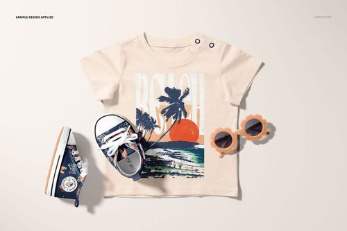 Infant t-shirt mockup with a beach and palm tree print, displayed flat with matching shoes and flower-shaped sunglasses.