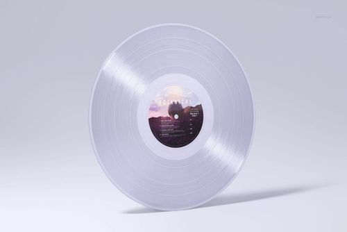 Clear colored vinyl record mockup shown standing on a flat surface with a scenic label, soft lighting.